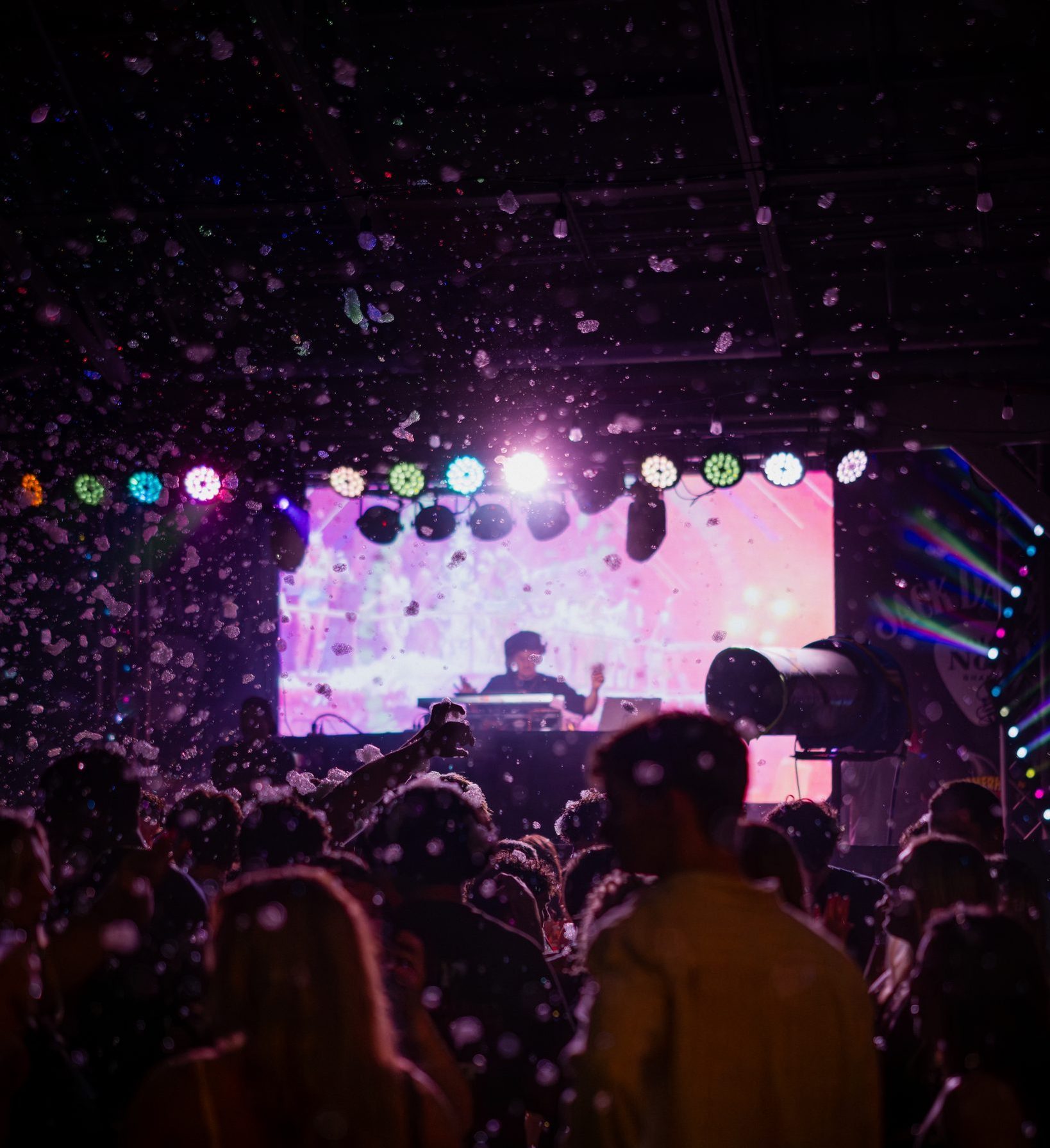 Foam drifting over the crowd facing the DJ stage at a Hammerhead Fred's foam party