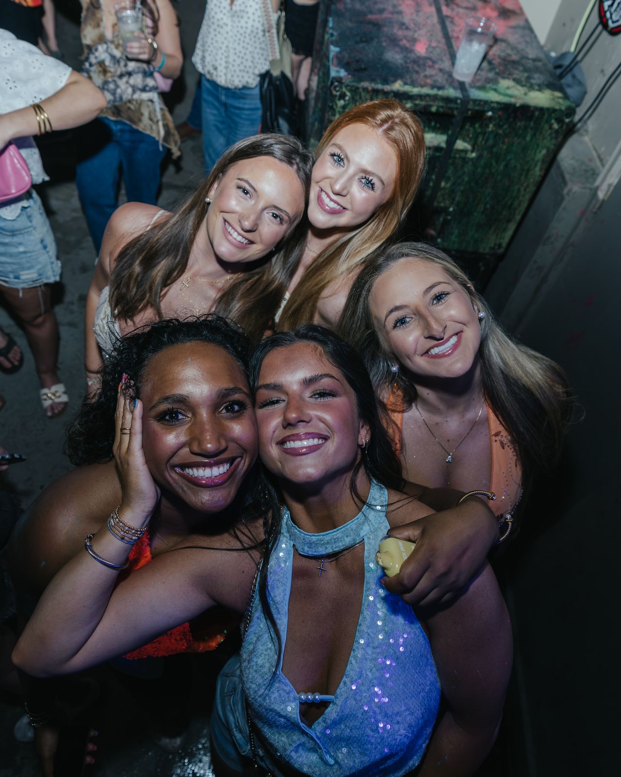 Four Friends Hugging Night Four friends hugging and smiling at a night party, Panama City Beach