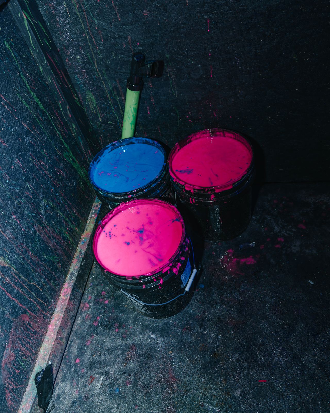 Buckets of pink and blue neon paint glowing in the dark, Panama City Beach