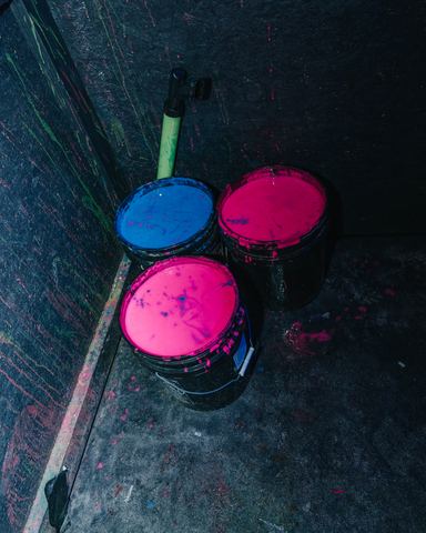Neon Paint Buckets Pink Blue Buckets of pink and blue neon paint glowing in the dark, Panama City Beach