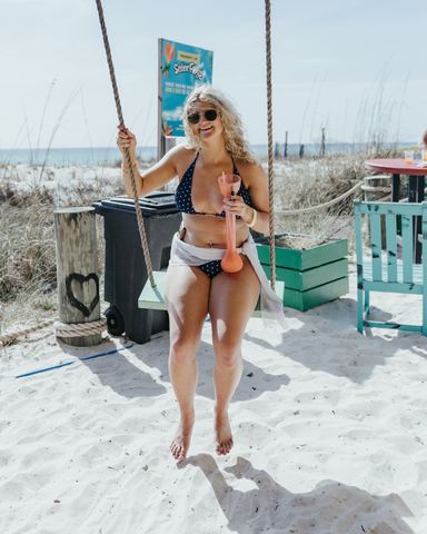 Woman Bikini Beach Swing Sunny - Senor Frog's Woman in a bikini sitting on a beach swing on white sand on a sunny day, Senor Frog's, Panama City Beach