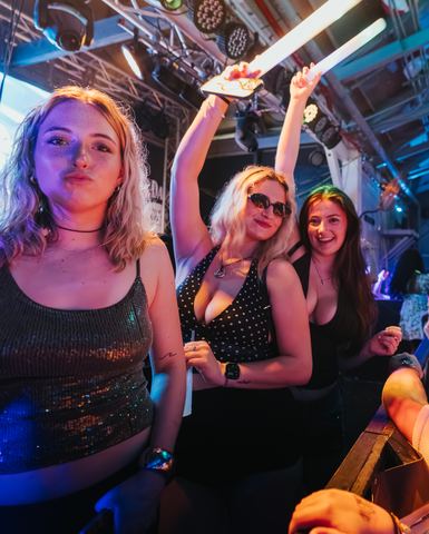 Three Women Smiling Stage Rail Three women smiling together at the stage rail at night, Panama City Beach
