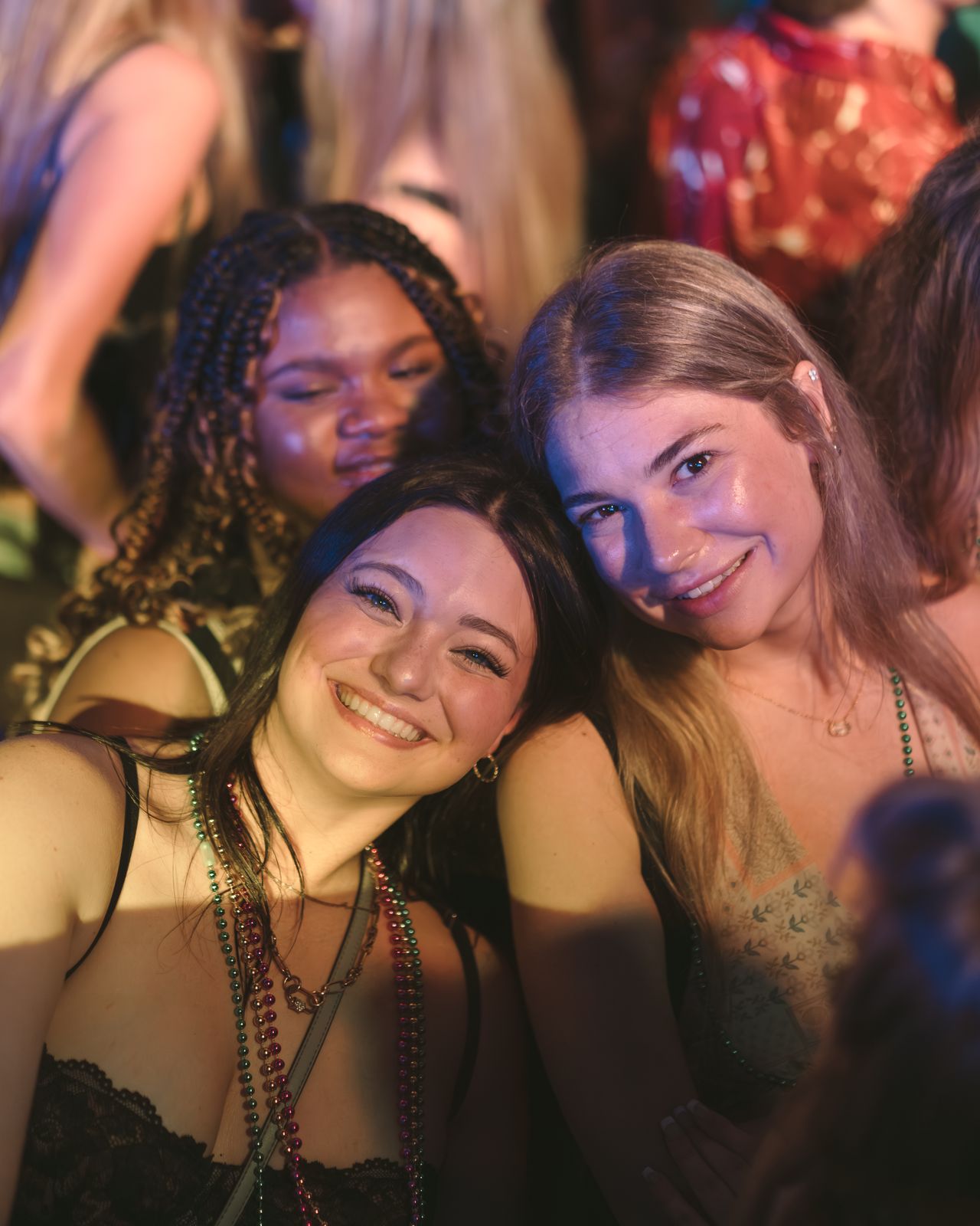 Two Women Bead Necklaces Smiling Two women in bead necklaces smiling close together at a night party, Panama City Beach