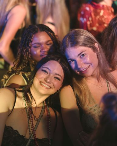 Two Women Bead Necklaces Smiling Two women in bead necklaces smiling close together at a night party, Panama City Beach