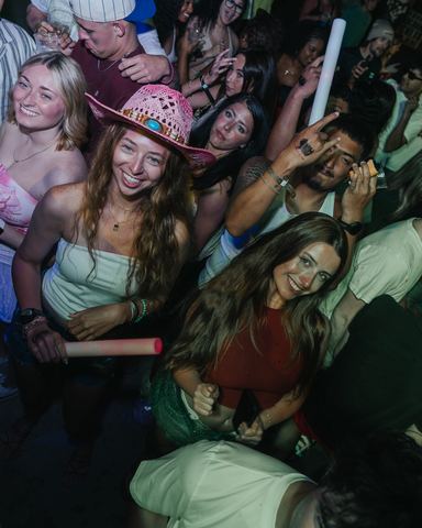 Woman Pink Cowboy Hat Smiling Woman in a pink cowboy hat smiling at the camera in a crowd, Panama City Beach